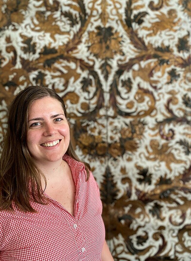 Restorer Vilde Dalåsen in front of gold leather wallpaper at her workplace, the National Museum. Image source: National Museum of Norway