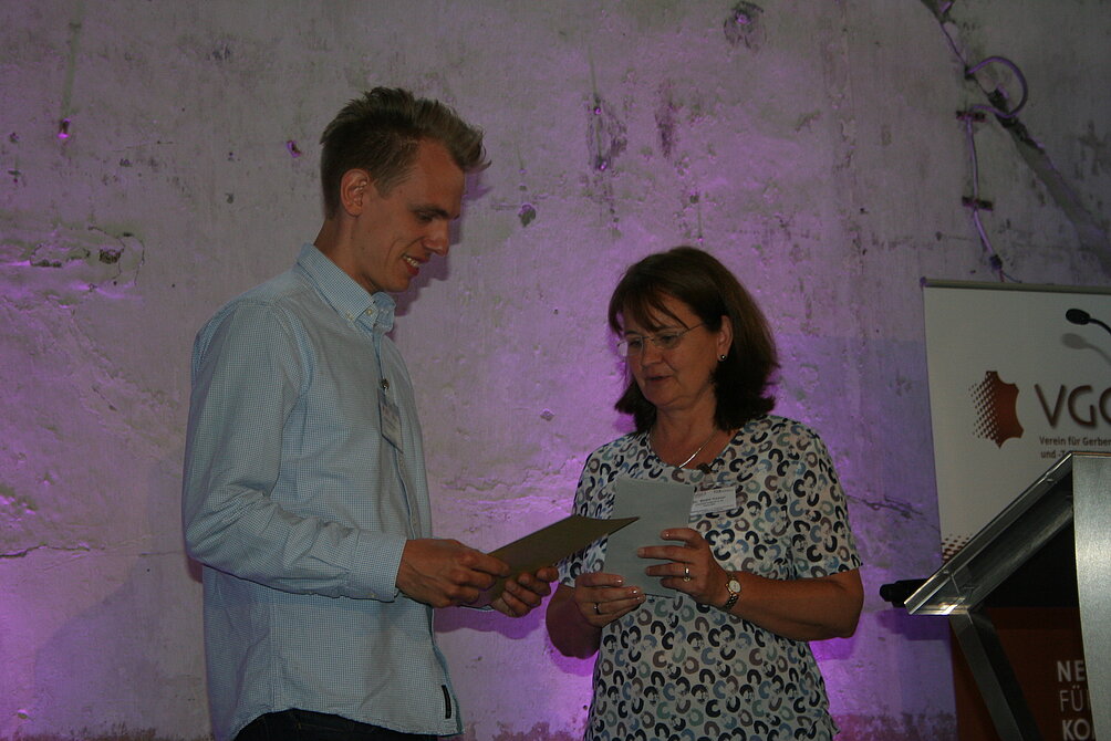 Dr. Beate Haaser (VGCT) hands over another VGCT promotional award for the second-best apprentice to Mads-Holst Jensen (former with Scan Hides)